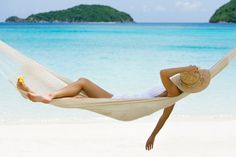 woman relaxing in a hammock on tropical beach